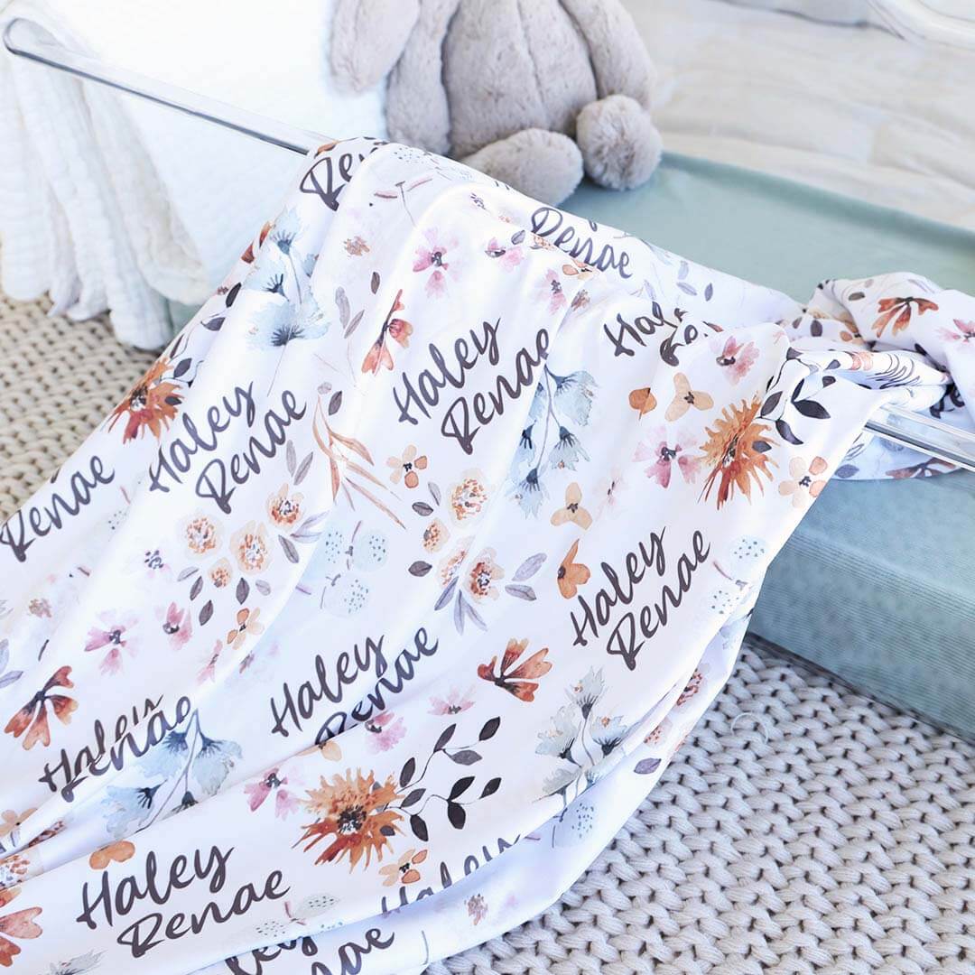 11168-lorelai-s-floral-personalized-baby-name-swaddle-blanket-1.jpg