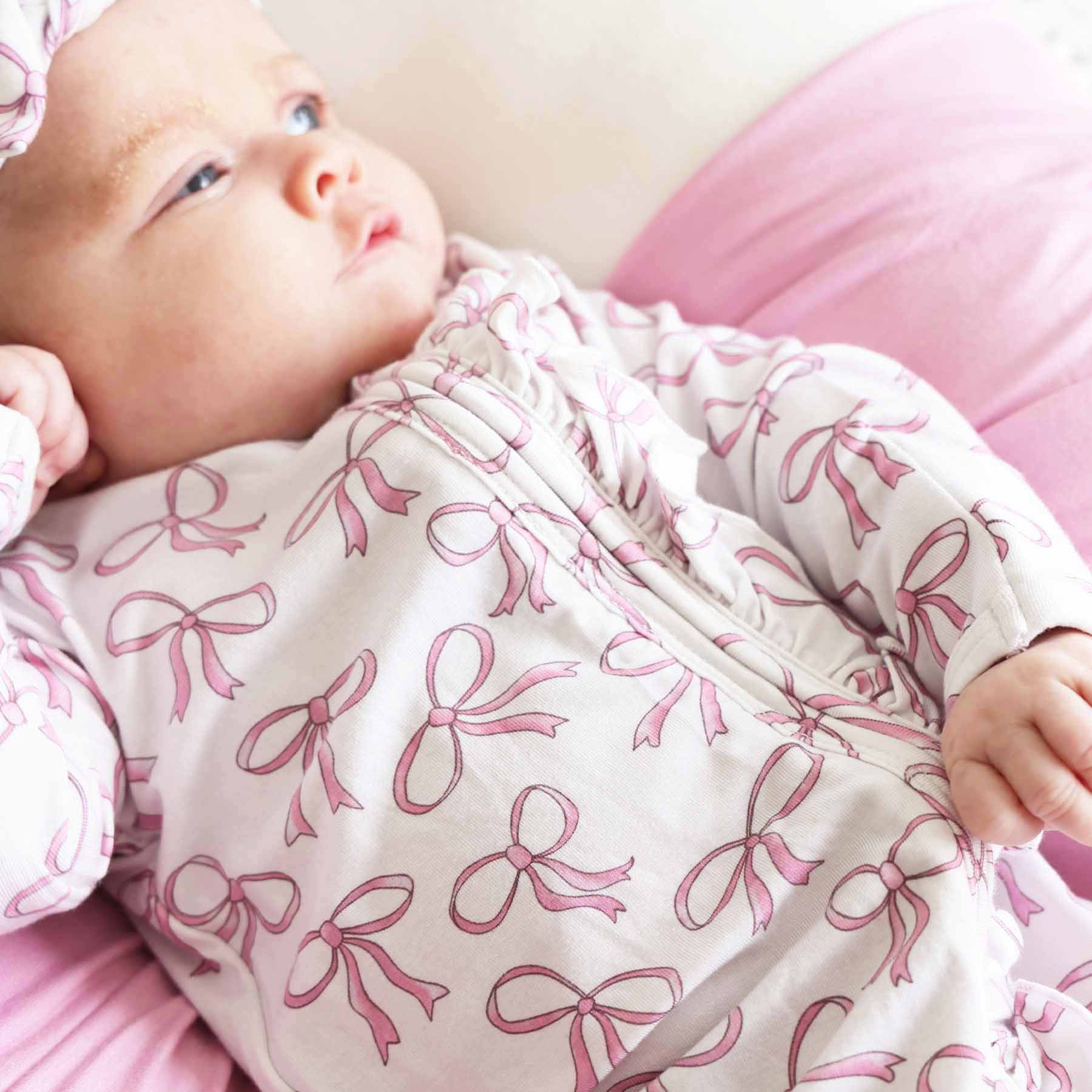 7459-blushing-bows-ruffle-zipper-footie-1.jpg