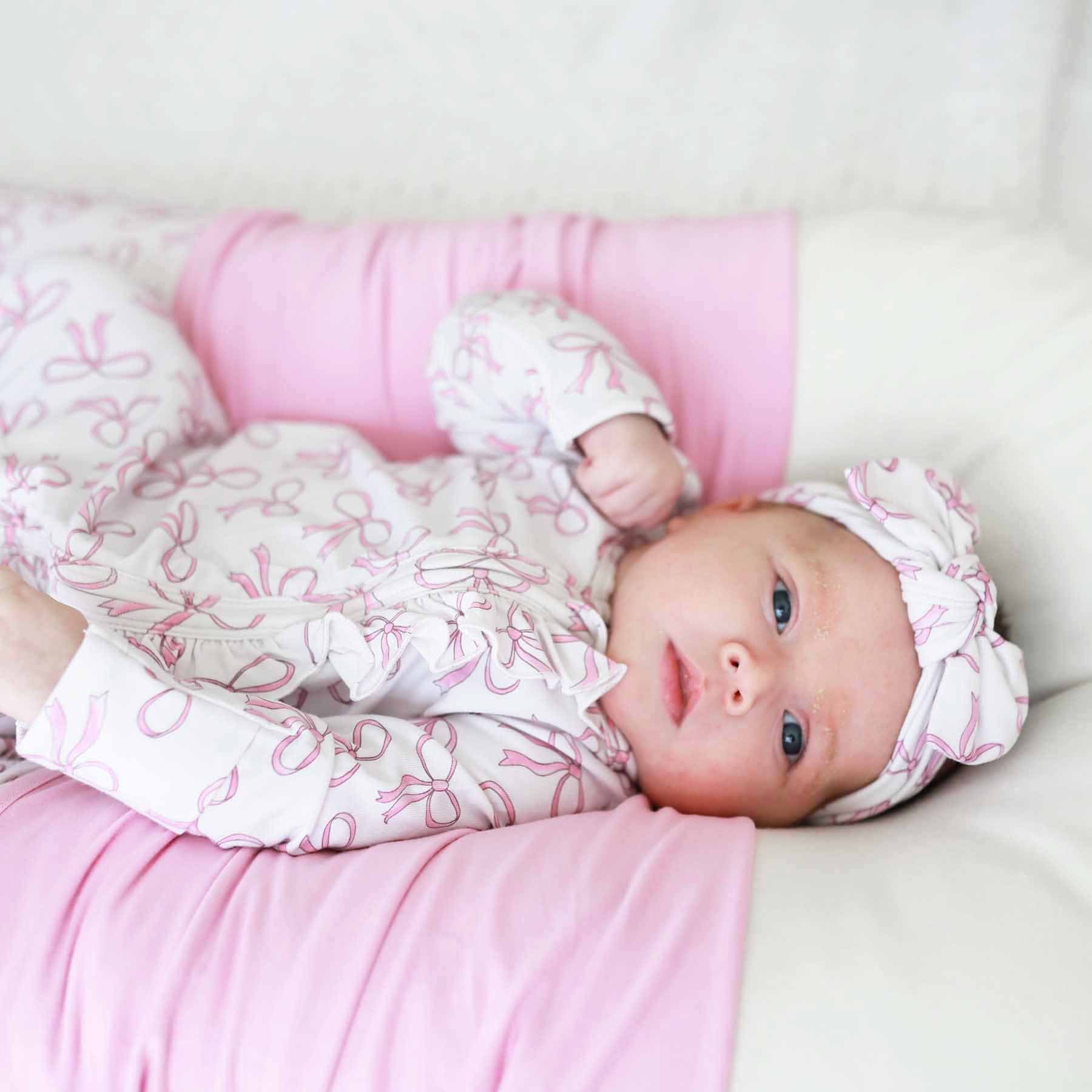 7459-blushing-bows-ruffle-zipper-footie-1.jpg