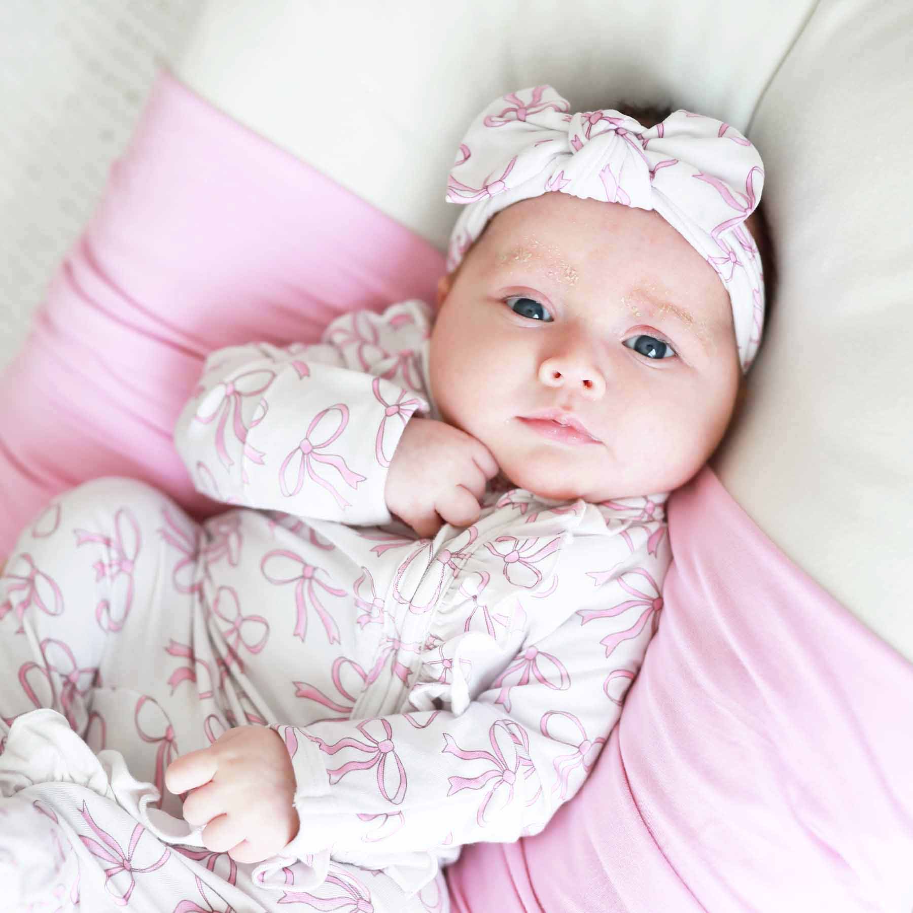 7459-blushing-bows-ruffle-zipper-footie-1.jpg
